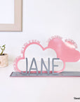 A decorative, customizable, colorful and modern gift for a newborn's or baby's room in the shape of a cloud, personalized to his name. Designed and produced by Steelouette.