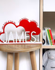 A decorative, customizable, colorful and modern gift for a newborn's or baby's room in the shape of a cloud, personalized to his name. Designed and produced by Steelouette.