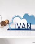 A decorative, customizable, colorful and modern gift for a newborn's or baby's room in the shape of a cloud, personalized to his name. Designed and produced by Steelouette.