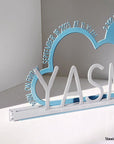 A decorative, customizable, colorful and modern gift for a newborn's or baby's room in the shape of a cloud, personalized to his name. Designed and produced by Steelouette.