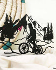 Steel decorative and gift item showcasing a scenic bike ride along the mountains, perfect for outdoor enthusiasts and nature lovers.