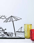 steel decorative gift item of a beach, sun, boat, parasol, typical summer day