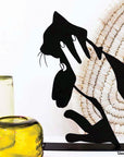 Steel decorative and gift item of a hand carrying a cat
