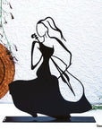 Steel decorative gift item featuring a woman playing on the cello