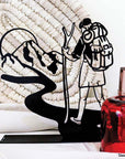 Steel decorative gift item featuring a scout ready for adventure, complete with backpack and walking stick
