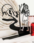 Steel decorative gift item featuring a scout ready for adventure, complete with backpack and walking stick