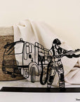 Steel decorative gift item featuring a firefighter