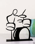 steel decorative gift item of a man playing on a drums