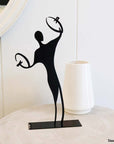 steel decorative gift item of a man playing on cymbales