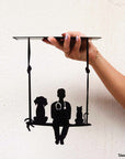 steel decorative gift item of a vet sitting between a cat and a dog