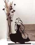 Steel decorative gift item featuring a woman playing on the cello
