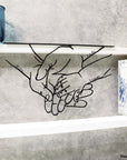 Steel decorative and gift item of the hands of a family, hands in hand