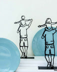 Steel decorative and gift item depicting a father carrying their child on their shoulders