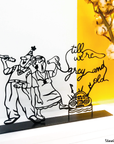 Steel decorative gift item featuring a grandmother and grandfather listening to radio music