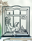 Steel decorative gift item featuring a woman reading a book and drinking coffee
