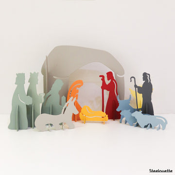 Steel decorative gift item showcasing a vibrant Christmas crib scene, complete with colorful figures