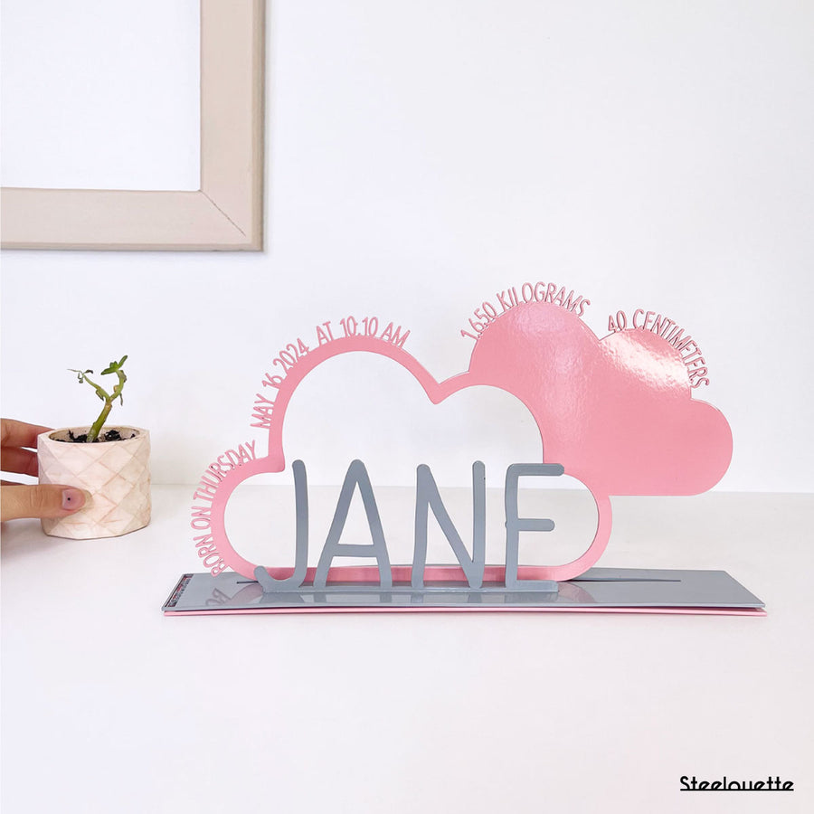 A decorative, customizable, colorful and modern gift for a newborn's or baby's room in the shape of a cloud, personalized to his name. Designed and produced by Steelouette.