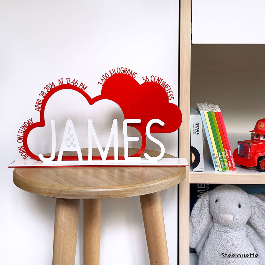 A decorative, customizable, colorful and modern gift for a newborn's or baby's room in the shape of a cloud, personalized to his name. Designed and produced by Steelouette.