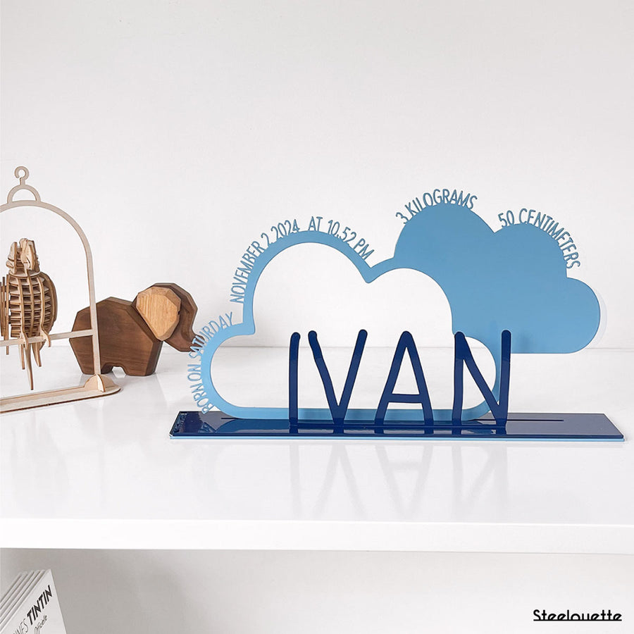 A decorative, customizable, colorful and modern gift for a newborn's or baby's room in the shape of a cloud, personalized to his name. Designed and produced by Steelouette.