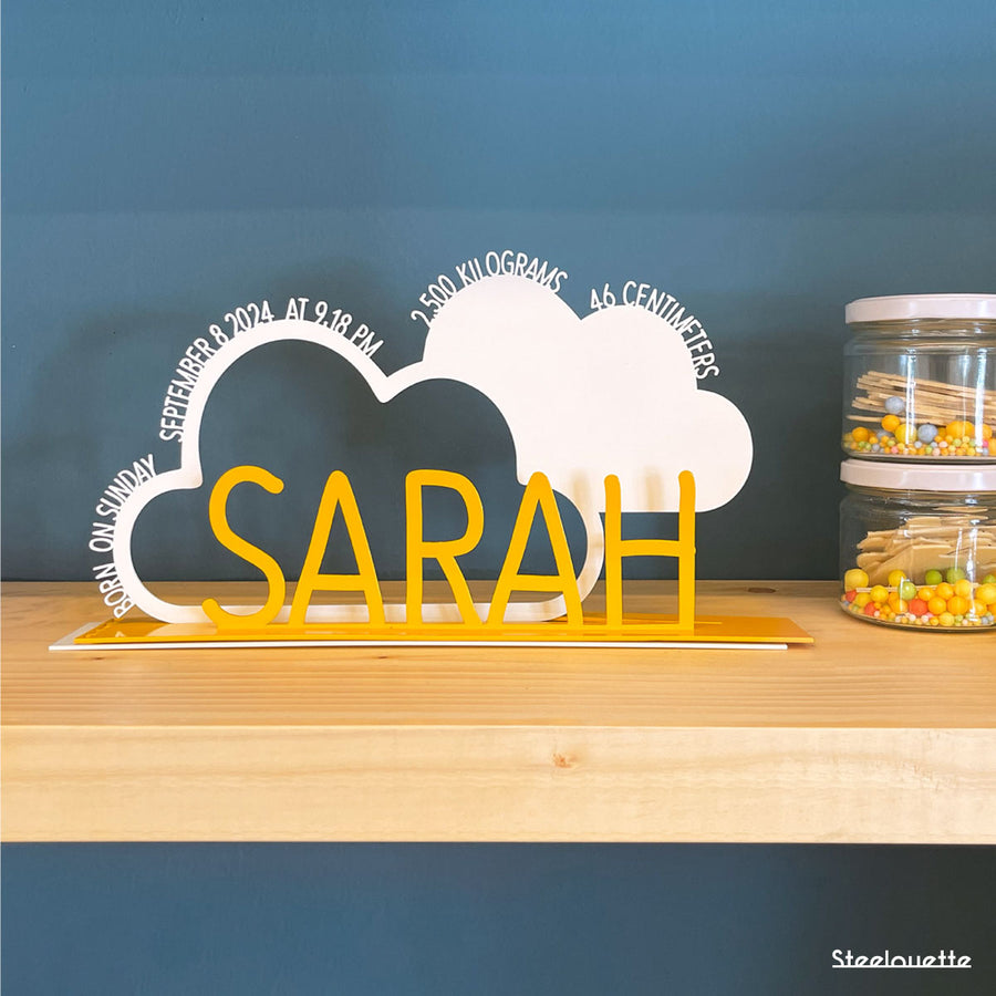 A decorative, customizable, colorful and modern gift for a newborn's or baby's room in the shape of a cloud, personalized to his name. Designed and produced by Steelouette.