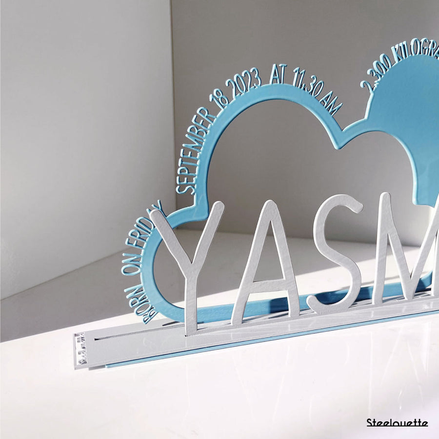 A decorative, customizable, colorful and modern gift for a newborn's or baby's room in the shape of a cloud, personalized to his name. Designed and produced by Steelouette.