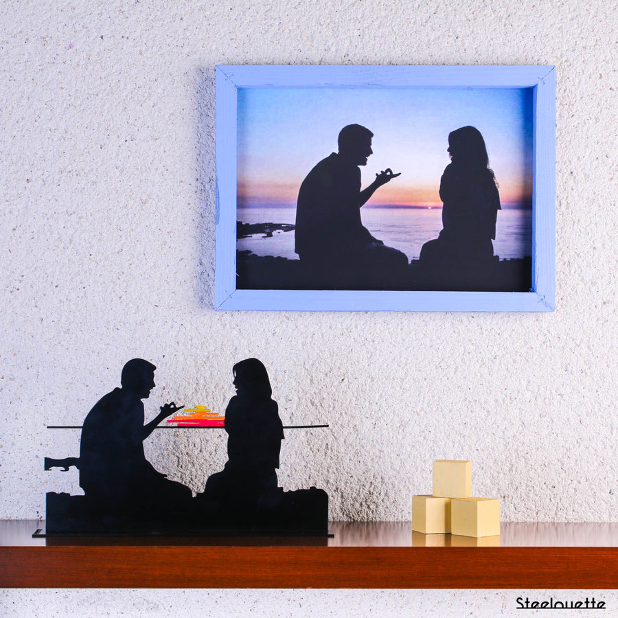 Steel decorative gift item featuring a couple at sunset