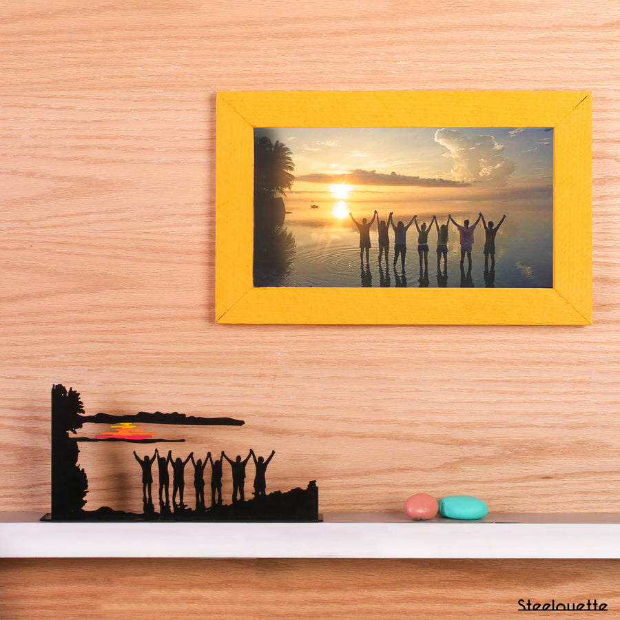 Steel decorative gift item featuring a group of friends at sunset