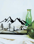 Steel decorative and gift item featuring a serene nature scene with trees, a hammock, mountains, and the moon.