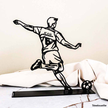 Steel decorative gift item featuring a boy kicking a ball