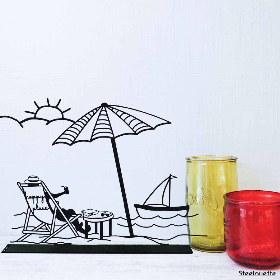 steel decorative gift item of a beach, sun, boat, parasol, typical summer day