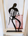 Steel decorative and gift item featuring an accordion dancer in action.