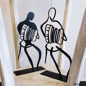 Steel decorative and gift item featuring accordion dancers in action.