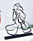 steel decorative gift item of a woman playing on a cello