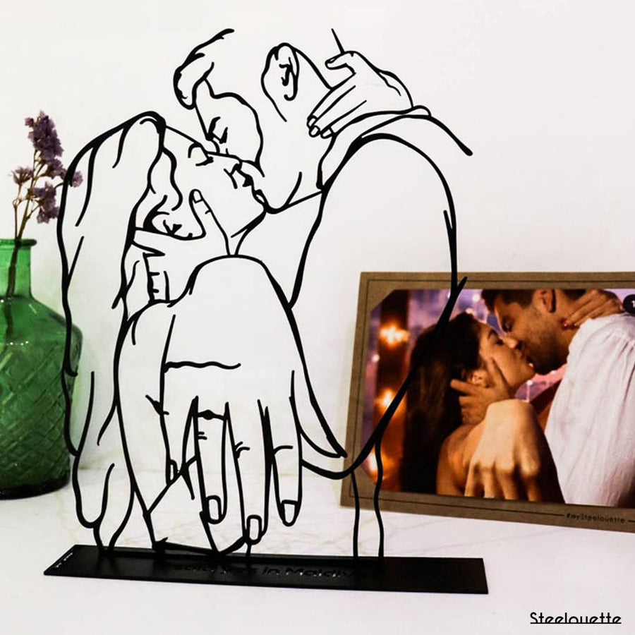 Steel decorative and gift item featuring a couple kissing