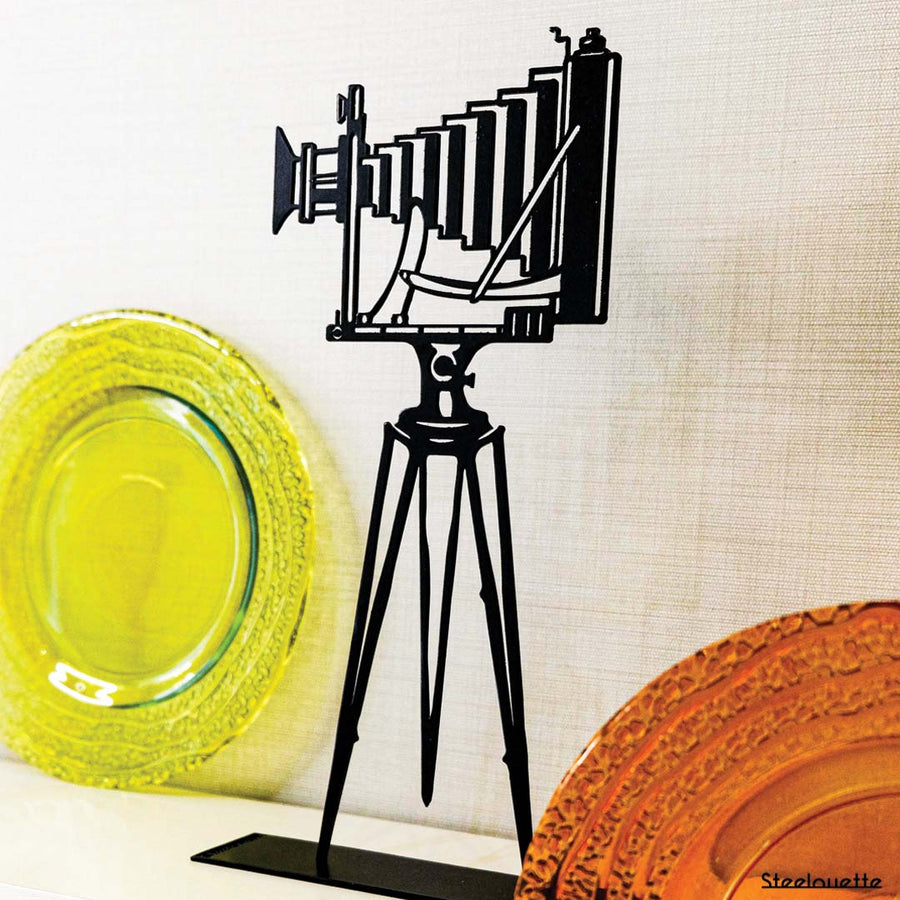 Steel decorative gift item featuring a professional camera with a stand