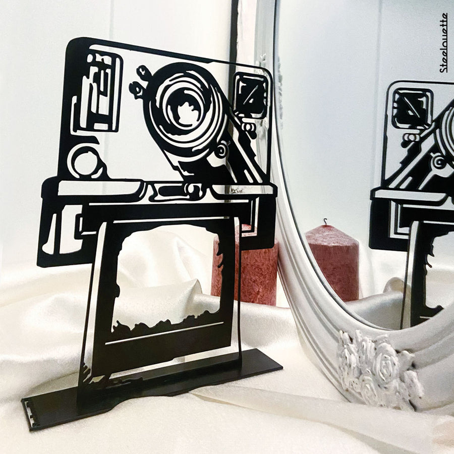 Steel decorative gift item featuring a polaroid camera