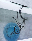Steel decorative gift item featuring a man and a woman hanging on a moon and planet