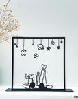 Steel decorative gift item featuring a couple laying on their back and looking at the stars