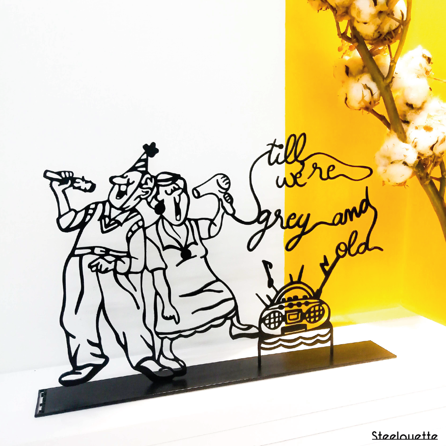 Steel decorative gift item featuring a grandmother and grandfather listening to radio music