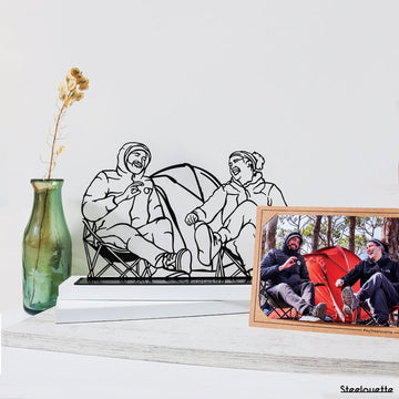 Steel decorative and gift item featuring friends camping and laughing