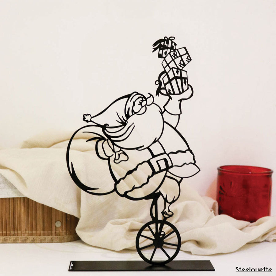 Steel decorative gift item featuring Santa Clause on a unicycle