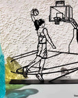 Steel decorative and gift item of a woman playing basketball
